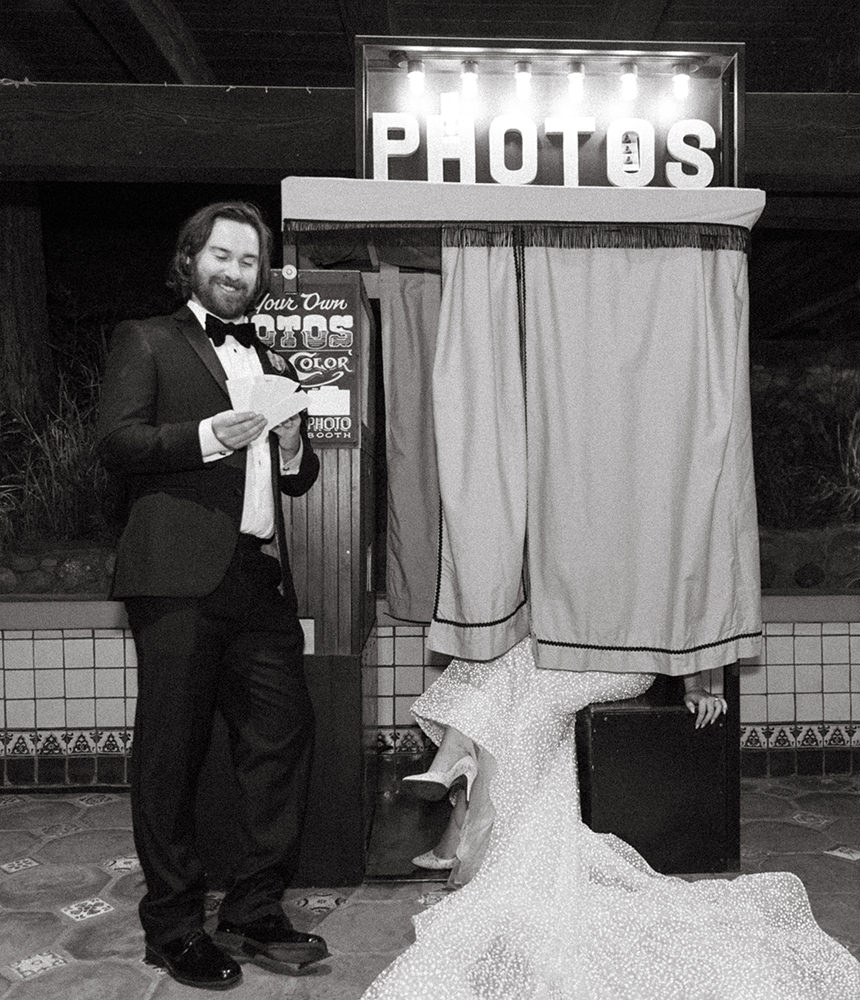 Groom and Bride in a vintage photo booth at their san diego wedding
