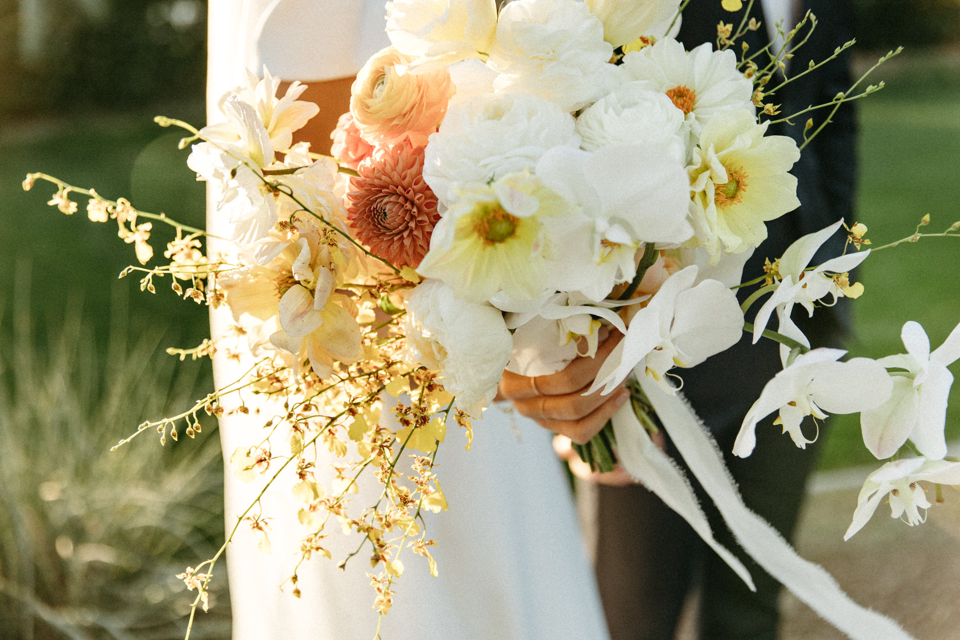 The Brides bouquet had a stunning mix of white orchids with some pops of yellow