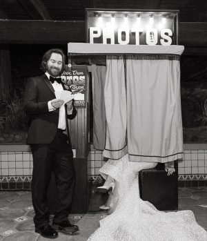 Groom and Bride in a vintage photo booth at their san diego wedding